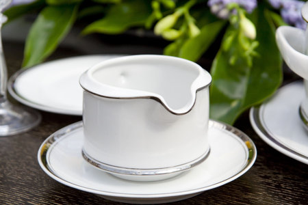 Dishware closeup with flower leaves in backgroundの写真素材