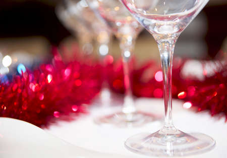 Wineglasses and red decorations in background, shallow focusの写真素材
