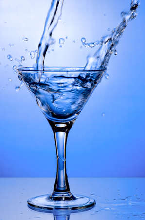 Pouring drink in martini glassの写真素材