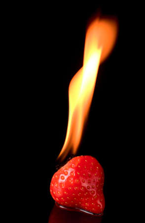 Burning strawberry with flamesの写真素材