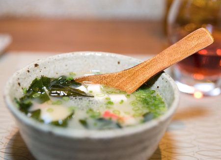 Miso soup of crab meat, tofu cheese, seaweed and green onion, shallow focus