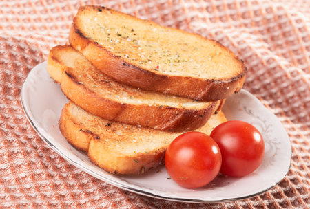 Three pieces of toasted bread and cherry tomatos