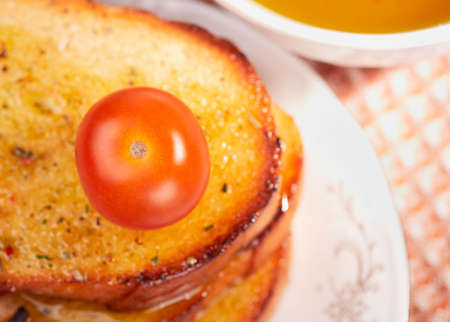 Toasts, olive oil and cherry tomato, focus ot tomatoの写真素材