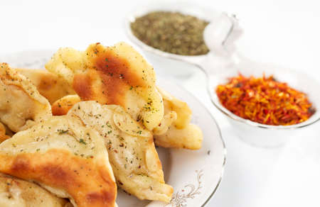 Fried ravioli in plate, aromatic herm and saffron in backgroundの写真素材