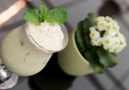  Creamy cocktail on table with flower pot