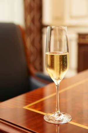 Glass of champagne on table in conference roomの写真素材