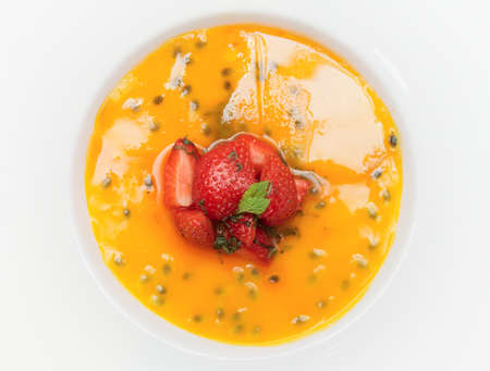 Delicious creme brulee with strawberries and mint in plate, isolatedの写真素材
