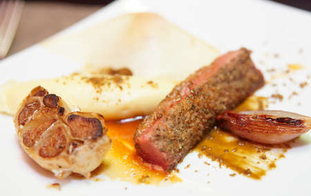 Red lamb meat on porcelain plateの写真素材