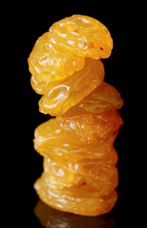 Heap of raisin isolated on black background, studio macro lens shotの写真素材