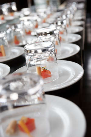 Small salmon snacks covered with glasses, selective focusの写真素材