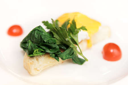 Toast with poached egg and spinach on plateの写真素材