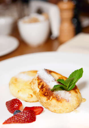 Cheese pancakes with fresh berries on white plate, restaurantの写真素材