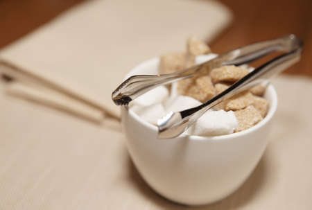 Sugar bowl with refined and brown cane sugar on restaurant table, selective focusの写真素材