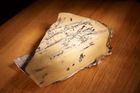 Blue cheese on wooden plank, still life, light painting