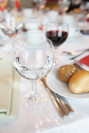 Glass with still water on a restaurant tableの写真素材