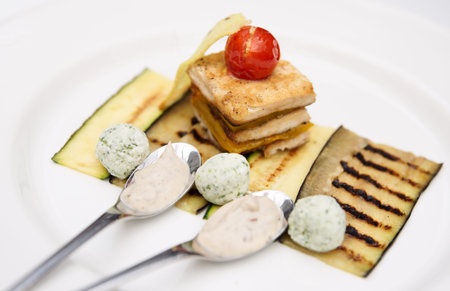 Creative dish with soft cheese, fish and grilled eggplant