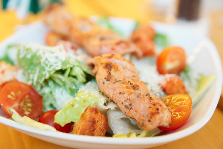 Caesar salad with grilled chicken fillet, parmesan cheese and croutonsの写真素材