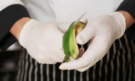 Chef is peeling avocado to make an appetizer の写真素材