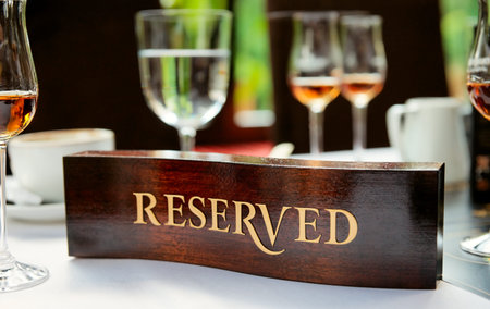 Wooden reserved plate on an arranged restaurant table 