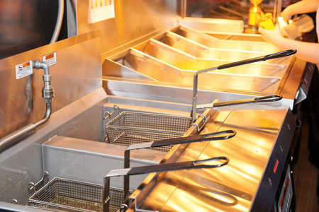 Deep fryer with boiling oil on restaurant kitchen の写真素材