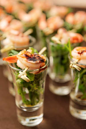 Tasty appetizer of shrimps and arugula on restaurant tableの写真素材