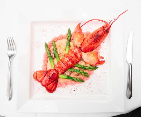Prepared lobster on porcelain plate, place settingの写真素材
