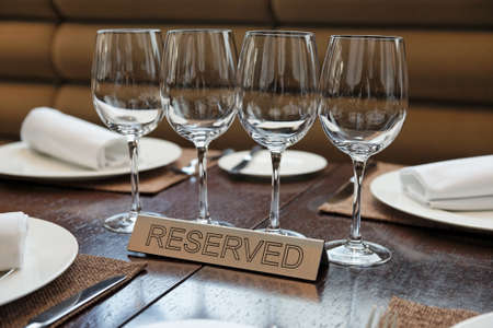 Reserved plate on an arranged restaurant tableの写真素材