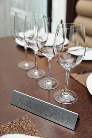 Reserved plate on an arranged restaurant table の写真素材