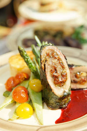 Meat roll with vegetables on plateの写真素材