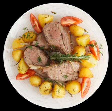 Rustic style rack of lamb with fried potatoes isolated on blackの写真素材