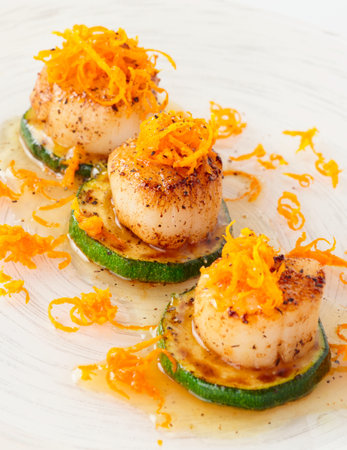 Pan fried scallops with citrus zest close-up