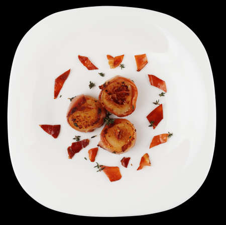 Fried scallops  on plate isolated on black backgroundの写真素材