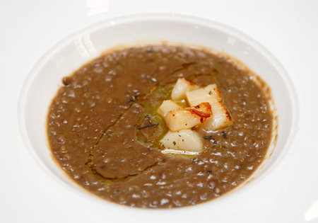 Lentil stew with scallops in plate - hearty but unpleasantly looking dish