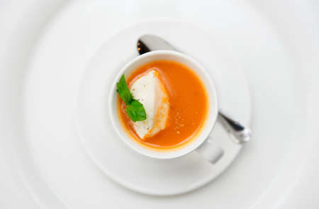 Small snack - gazpacho soup served in coffee cup with whipped creamの写真素材