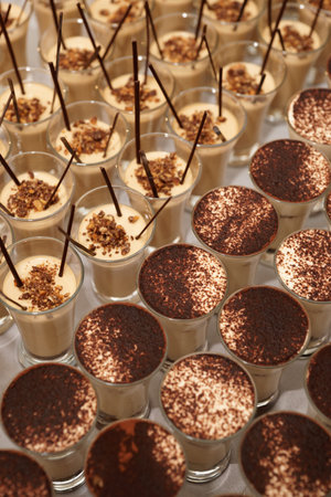 A lot of chocolate desserts in shot glasses, close-up