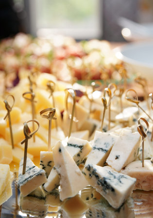 Selection of cheese on banquet table, close-up, copy space
