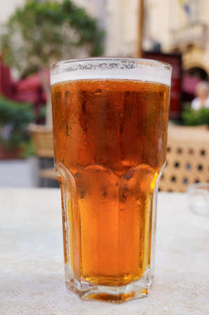Glass of beer on restaurant table, close-upの写真素材