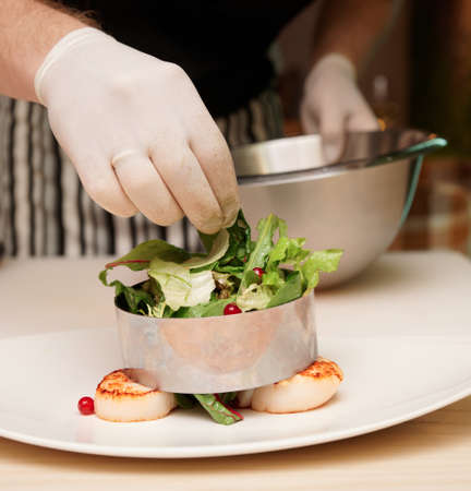 Chef is cooking appetizer with scallops, close-upの写真素材