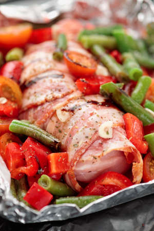 Chicken breast wrapped in bacon before bakingの写真素材