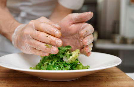Chef is decorating an appetizer at professional kitchen