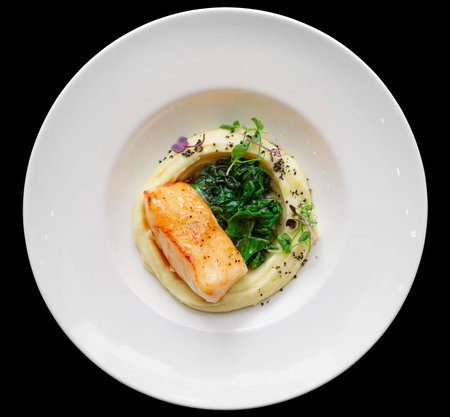 Fried fish fillet with potato mash on restaurant table