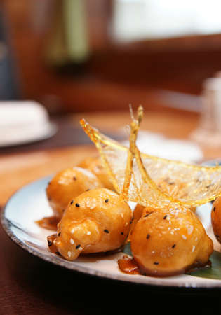 Caramelized fruits in dough, chinese dessert, in plateの写真素材