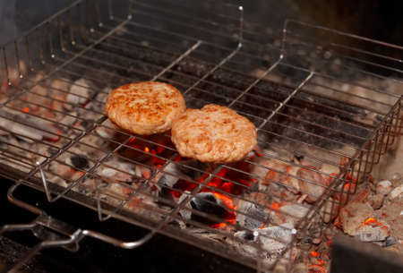 Beef cutlets being fried on charcoal grillの写真素材