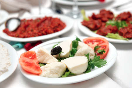 Mozzarella with tomatos and other appetizers on restaurant tableの写真素材