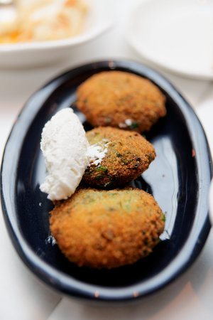 Vegetable pate with sour cream in black plate, close-up