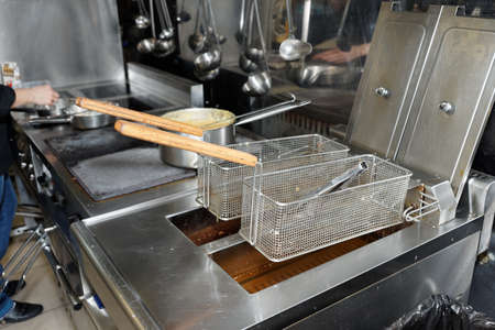 Deep fryers with boiling oil on fast food kitchen の写真素材
