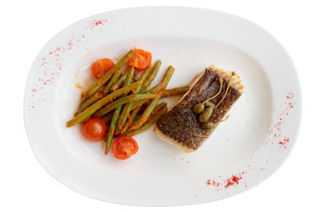 Cod fillet with runner beans on plate isolated on white background の写真素材