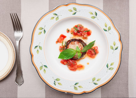 Eggplant with cheese and tomatoes on plate