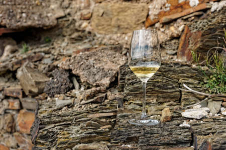 Glass of Riesling wine on a slate rockの写真素材