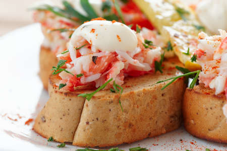 Crab meat with toast, sauce and fresh herbs, close-upの写真素材